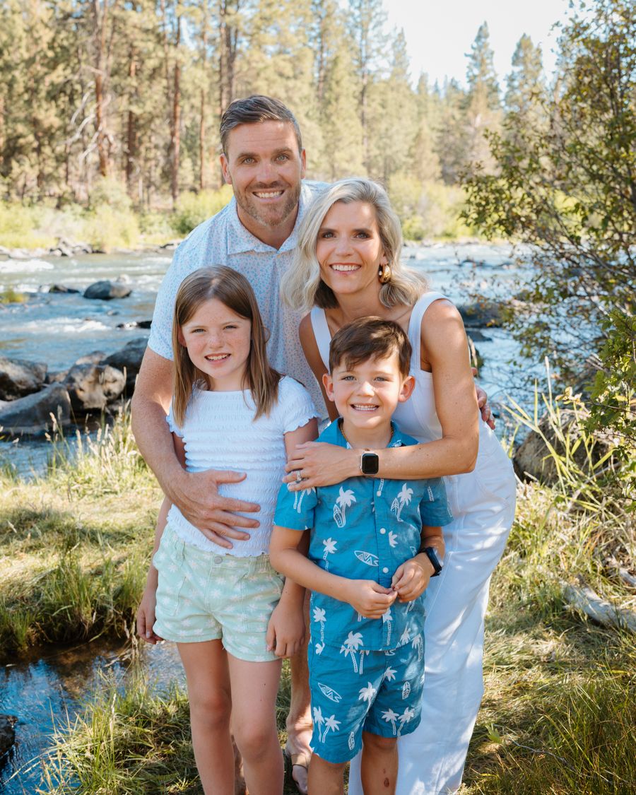 Brendan with his wife and two children by a river